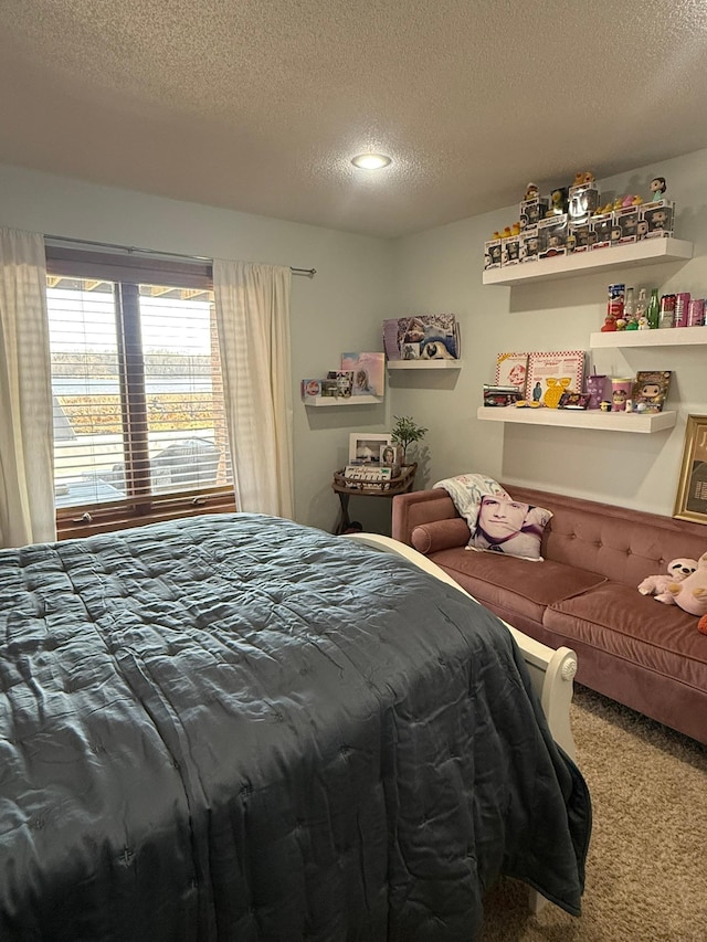 bedroom with carpet floors and a textured ceiling