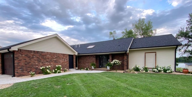ranch-style house with a front lawn and brick siding