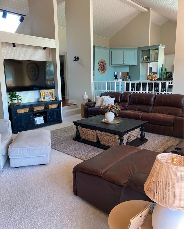 carpeted living area featuring high vaulted ceiling