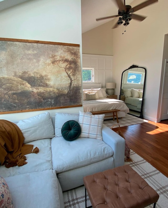 living room featuring ceiling fan, lofted ceiling, and wood finished floors