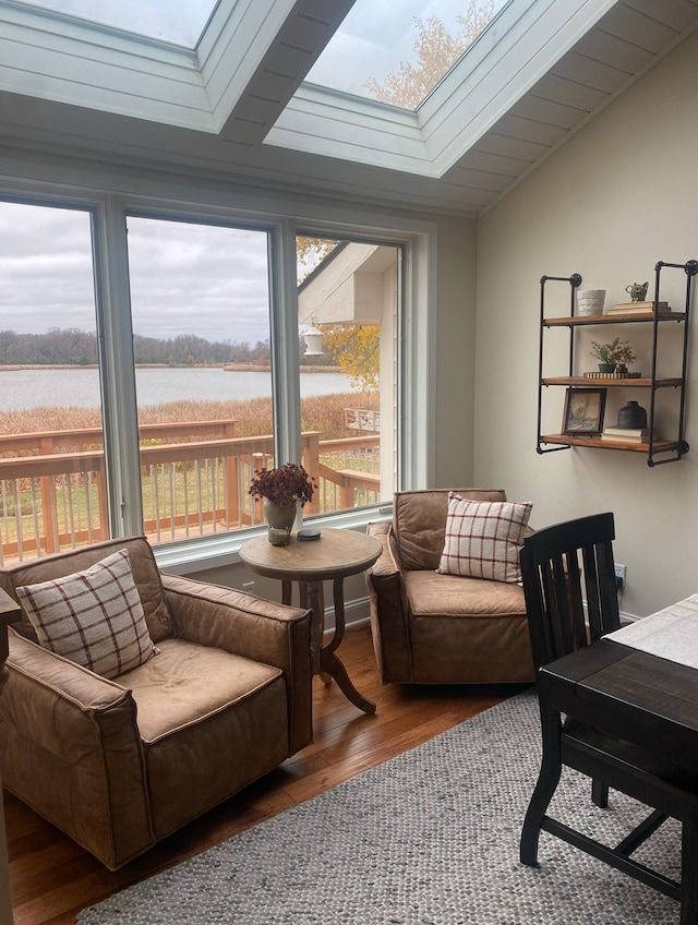 sunroom with a skylight and a water view