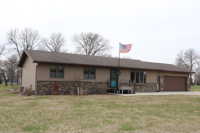 ranch-style home featuring stone siding, a garage, central air condition unit, a front yard, and driveway