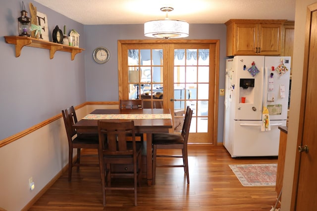 dining space with light wood-type flooring, baseboards, and french doors