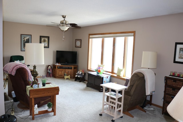carpeted living area featuring a ceiling fan