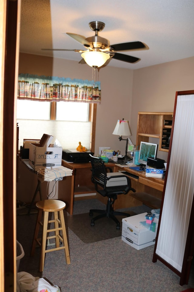 carpeted office featuring ceiling fan