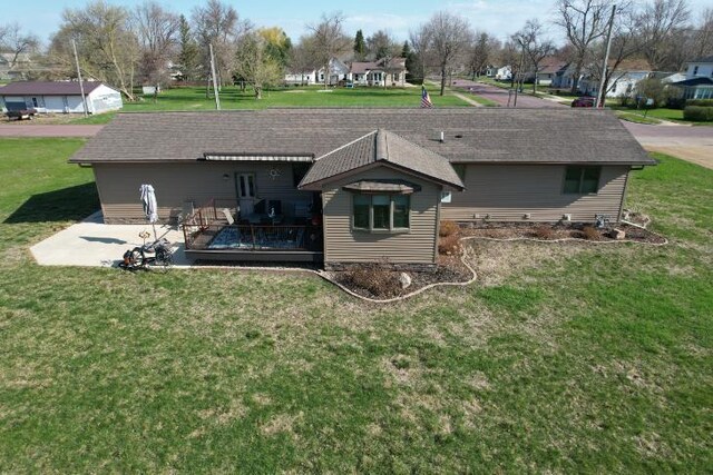 rear view of property featuring a residential view and a lawn