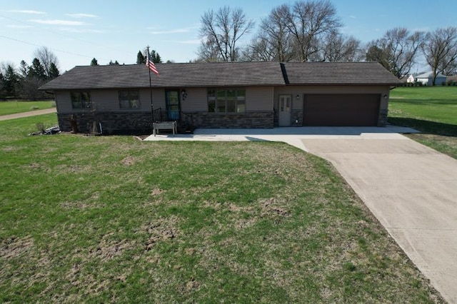 ranch-style home with stone siding, a garage, concrete driveway, and a front yard