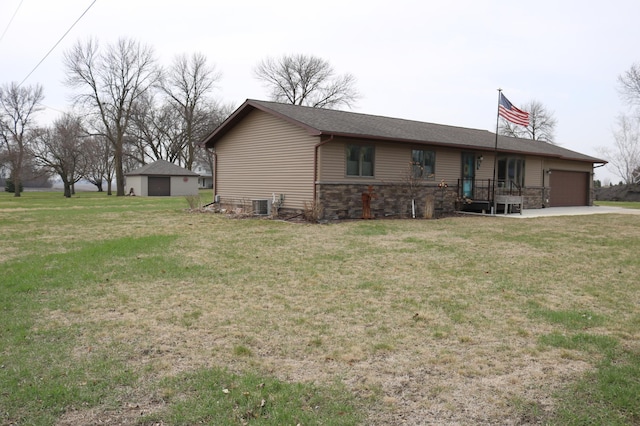single story home with stone siding, central air condition unit, an attached garage, and a front lawn