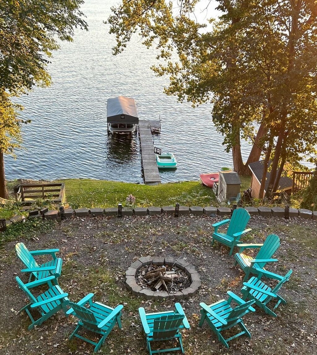 5975 Devitt Ave NW, Maple Lake Twp, MN 55358 - exterior space with boat lift, a water view, an outdoor fire pit, and a dock