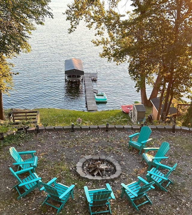 5975 Devitt Ave NW, Maple Lake Twp, MN 55358 - exterior space with boat lift, a water view, an outdoor fire pit, and a dock