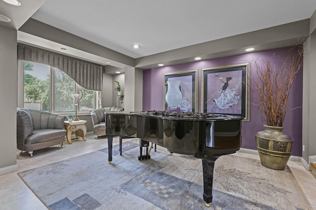 living area featuring baseboards and recessed lighting
