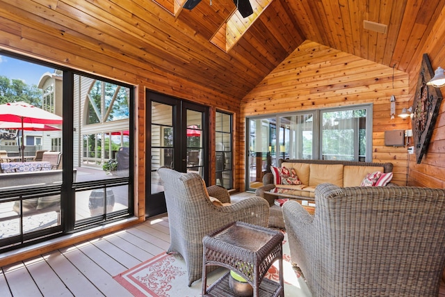 sunroom featuring ceiling fan, an outdoor hangout area, and a skylight