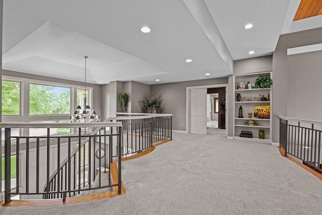 hallway with baseboards, built in shelves, an upstairs landing, recessed lighting, and carpet flooring