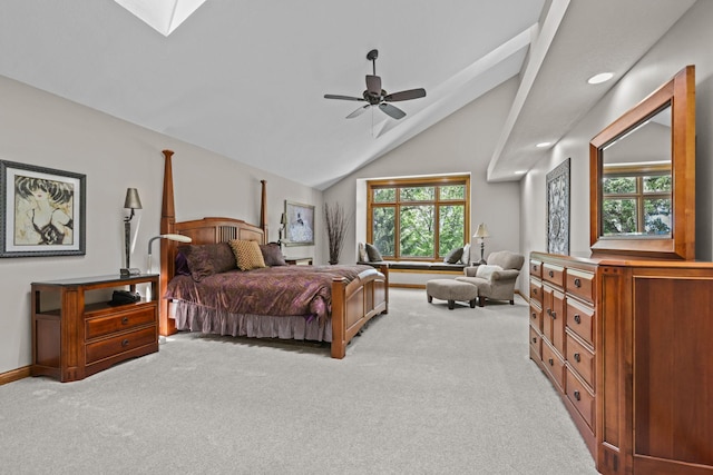 bedroom with recessed lighting, vaulted ceiling with skylight, light colored carpet, and baseboards