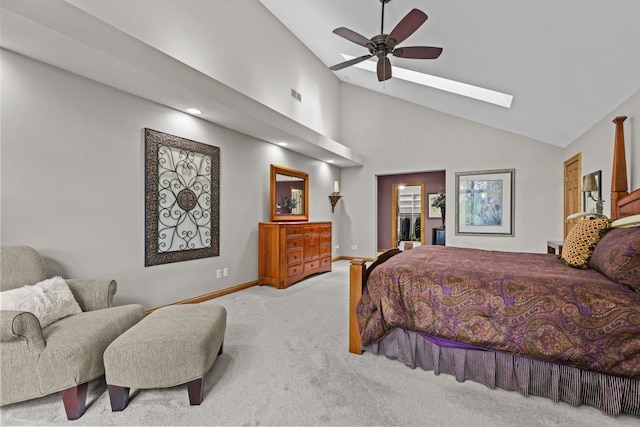 bedroom with high vaulted ceiling, visible vents, carpet floors, a skylight, and baseboards