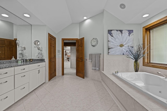 bathroom with vanity, vaulted ceiling, recessed lighting, tile patterned flooring, and a bath
