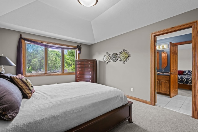 bedroom with light carpet, light tile patterned flooring, baseboards, and lofted ceiling