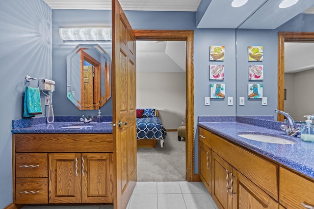bathroom featuring a sink, two vanities, and tile patterned flooring