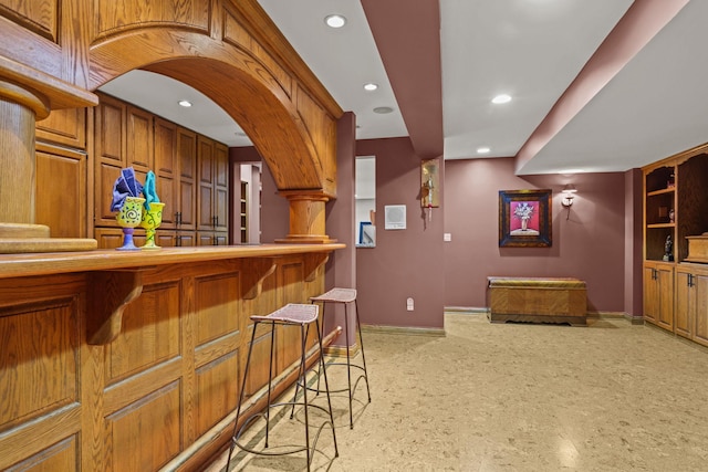 bar with baseboards and recessed lighting
