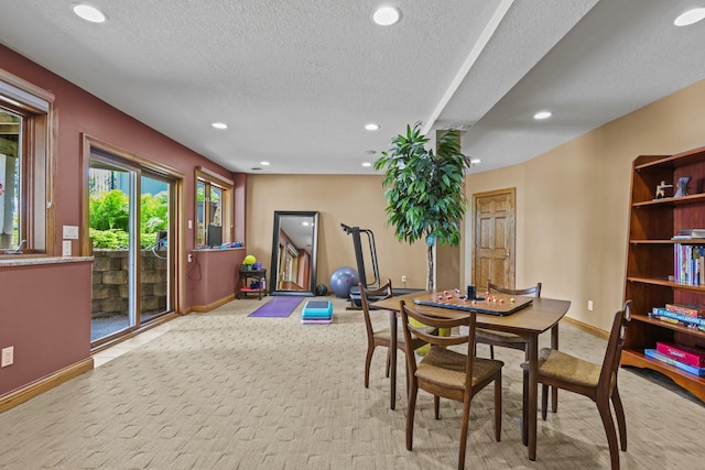 dining room featuring a textured ceiling, carpet flooring, baseboards, and recessed lighting