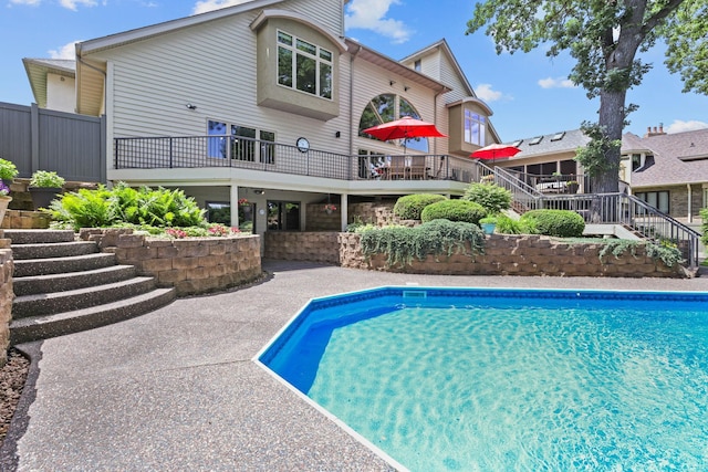 outdoor pool featuring a patio area and stairs