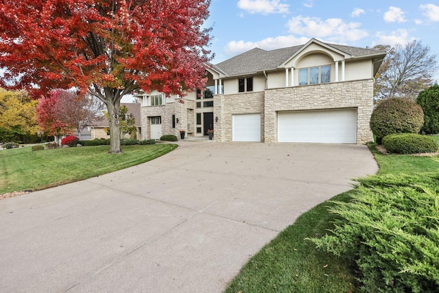 view of front of property featuring a front yard, an attached garage, stone siding, concrete driveway, and stucco siding