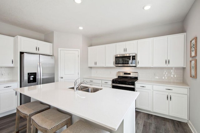 17030 Draper Way, Lakeville, MN 55044 - kitchen with stainless steel appliances, a sink, dark wood finished floors, decorative backsplash, and white cabinets