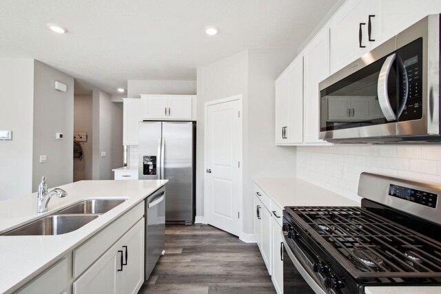 17030 Draper Way, Lakeville, MN 55044 - kitchen featuring appliances with stainless steel finishes, a sink, light countertops, dark wood-style floors, and white cabinets