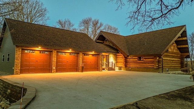 46174 County Highway 35, Vergas, MN 56587 - view of front facade featuring driveway, an attached garage, log siding, a shingled roof, and stone siding