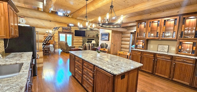 46174 County Highway 35, Vergas, MN 56587 - kitchen featuring rustic walls, hardwood / wood-style floors, wood ceiling, a center island, and brown cabinets