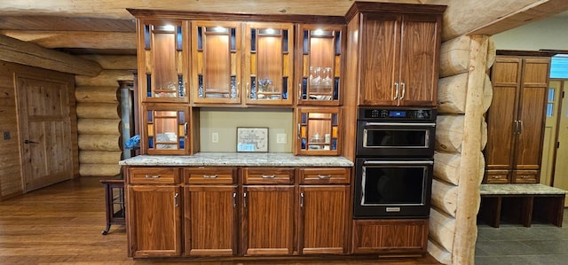 46174 County Highway 35, Vergas, MN 56587 - kitchen with rustic walls, light stone counters, dark wood finished floors, and brown cabinetry