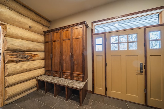 46174 County Highway 35, Vergas, MN 56587 - mudroom featuring rustic walls and dark tile patterned floors