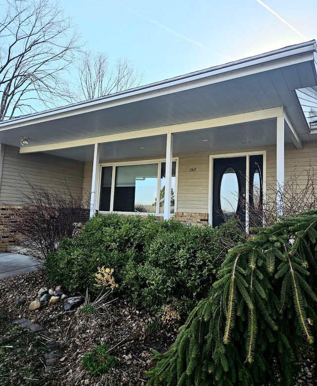 view of exterior entry with covered porch