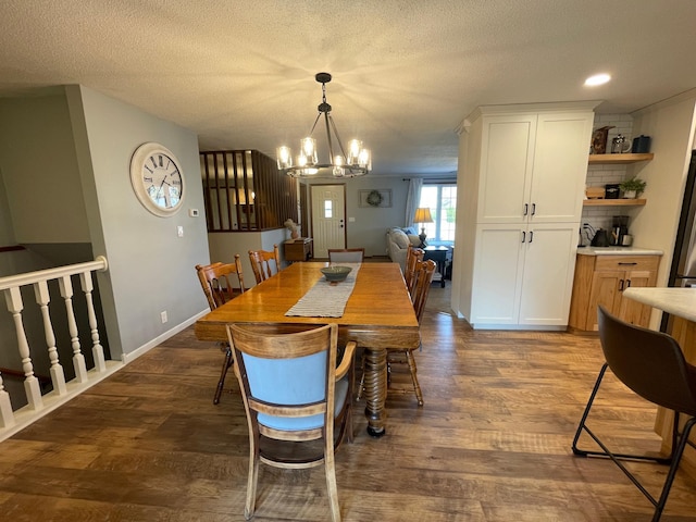 1211 Diagonal Rd, Worthington, MN 56187 - dining area featuring a chandelier, dark wood-type flooring, and a textured ceiling