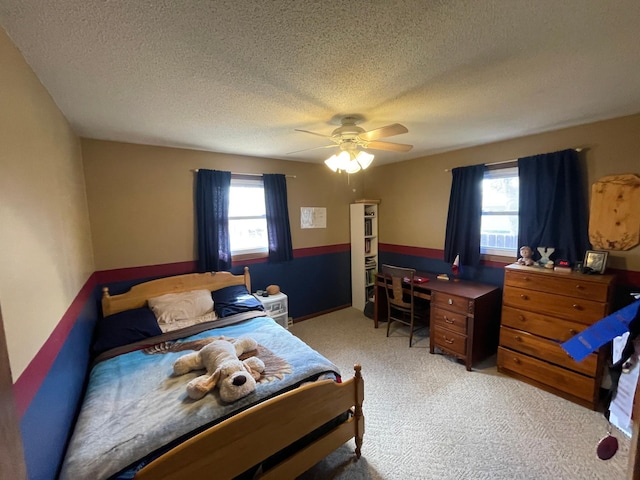 1211 Diagonal Rd, Worthington, MN 56187 - bedroom with multiple windows, light colored carpet, a textured ceiling, ceiling fan, and an office area