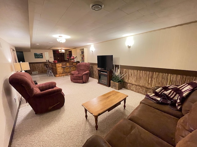 1211 Diagonal Rd, Worthington, MN 56187 - carpeted living room featuring bar, wainscoting, and wood walls