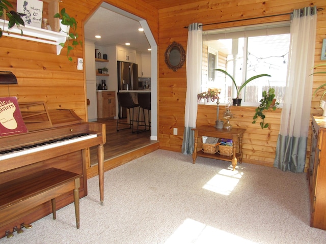 1211 Diagonal Rd, Worthington, MN 56187 - sitting room featuring wood walls, light colored carpet, recessed lighting, and arched walkways