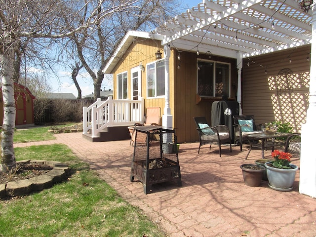 1211 Diagonal Rd, Worthington, MN 56187 - view of patio featuring a fire pit and a pergola