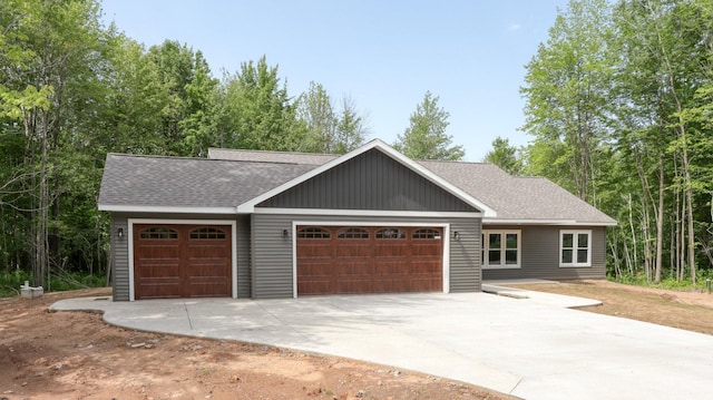 24888 65th Ave, Sigel Twp, WI 54727 - view of front of house featuring roof with shingles, concrete driveway, and an attached garage