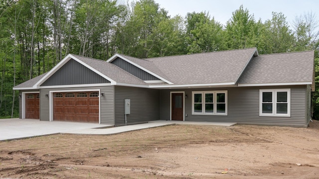 24888 65th Ave, Sigel Twp, WI 54727 - view of front of house with a shingled roof, a garage, and concrete driveway