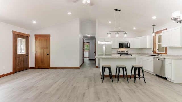 24888 65th Ave, Sigel Twp, WI 54727 - kitchen featuring appliances with stainless steel finishes, a kitchen island, white cabinets, healthy amount of natural light, and recessed lighting