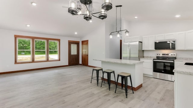 24888 65th Ave, Sigel Twp, WI 54727 - kitchen with appliances with stainless steel finishes, a kitchen island, a chandelier, white cabinetry, and a kitchen bar