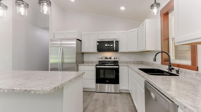 24888 65th Ave, Sigel Twp, WI 54727 - kitchen with appliances with stainless steel finishes, vaulted ceiling, light countertops, white cabinets, and recessed lighting