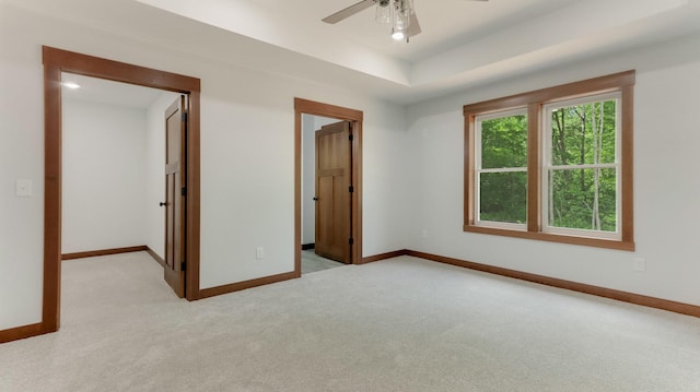 24888 65th Ave, Sigel Twp, WI 54727 - unfurnished bedroom featuring light colored carpet, ceiling fan, and a raised ceiling