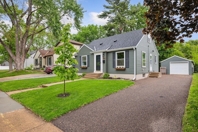 3011 Brunswick Ave S, Saint Louis Park, MN 55416 - view of front of home featuring a garage, an outbuilding, a shingled roof, driveway, and a front yard
