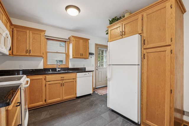 3011 Brunswick Ave S, Saint Louis Park, MN 55416 - kitchen featuring white appliances, dark countertops, a sink, and dark tile patterned floors