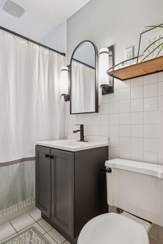 3011 Brunswick Ave S, Saint Louis Park, MN 55416 - bathroom featuring toilet, vanity, tile patterned floors, and tile walls