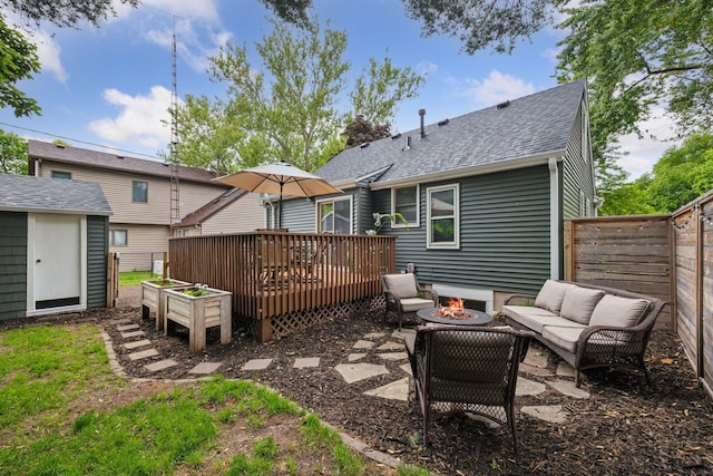 3011 Brunswick Ave S, Saint Louis Park, MN 55416 - rear view of property featuring roof with shingles, an outdoor living space with a fire pit, a deck, and a fenced backyard
