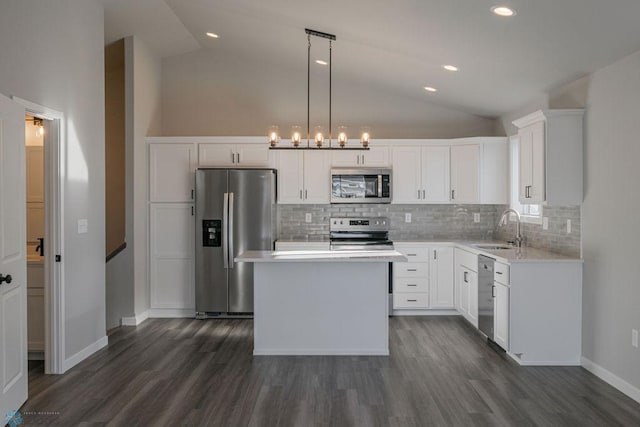 kitchen with a sink, decorative backsplash, lofted ceiling, and stainless steel appliances