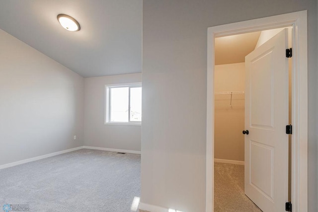 interior space with carpet floors, baseboards, and visible vents